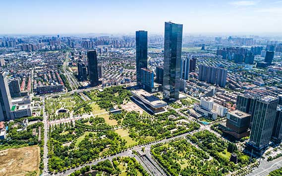 Aerial view of a modern urban skyline with green spaces – GHL Developers