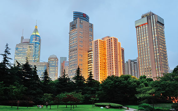 Aerial view of a modern urban skyline with green spaces – GHL Developers